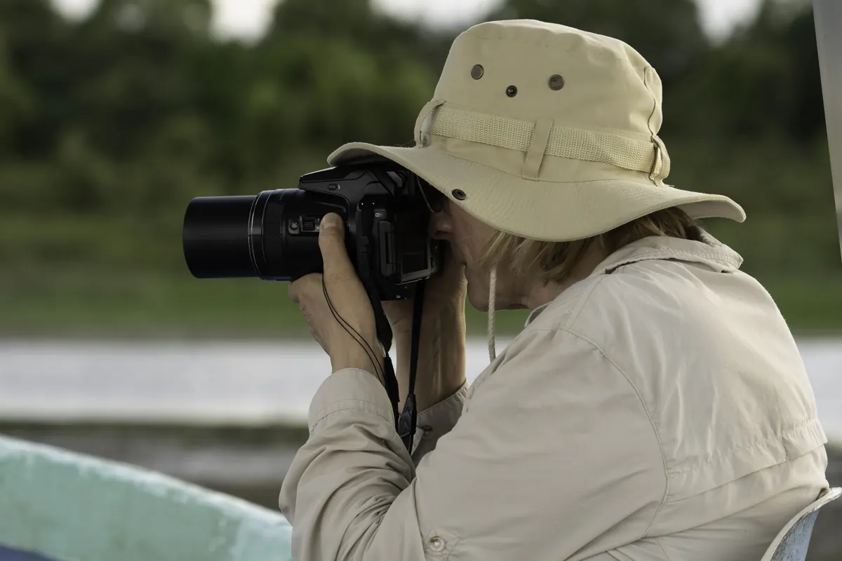 Physis guest photographing wildlife from a boat