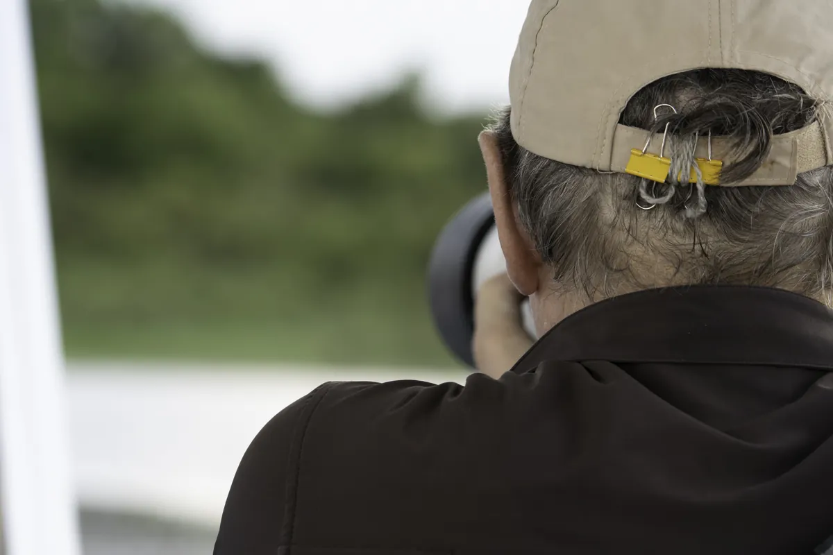 Physis guest photographing from a boat on a river session